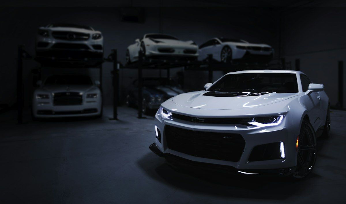 A silver sports car in an indoor showroom, original photo